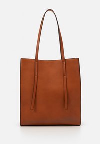Sac fourre-tout en cuir marron avec deux poignées allongées, design minimaliste, texture lisse et coutures subtiles le long des bords.
