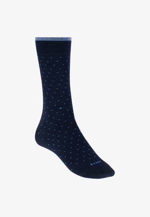 Marineblauer Socken mit kleinen hellblauen Punkten, hellblauem Bündchenrand und dem Schriftzug "BOGGI" nahe dem Zehenbereich.