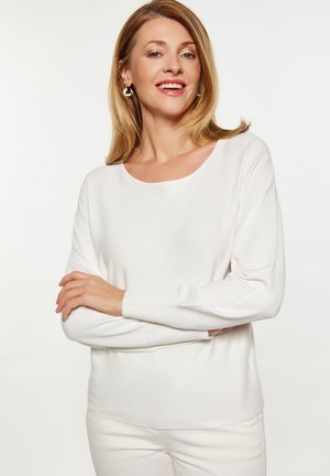 Witte lange mouwen top van een zachte, lichte stof met een lichte glans, met een ronde halslijn en ribgebreide manchetten.