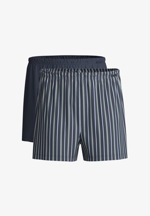 Two pairs of swim shorts, one solid navy and the other with navy and green vertical stripes. Elastic waistbands, soft fabric texture.