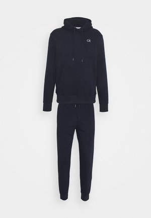 Navy blue cotton blend hoodie and joggers set. Hoodie features a front pocket and drawstrings; pants have elastic cuffs and waistband.