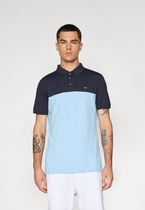 Polo shirt in light blue and navy, made of cotton, featuring a collared neck, three-button placket, and CK logo on the chest.