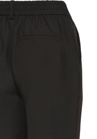 Pantalon noir avec une ceinture élastique, offrant une texture lisse et une seule poche arrière. Le tissu semble léger et polyvalent.