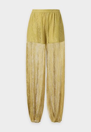 Gelbe Spitzenhose mit solidem oberen Bereich und transparenten Spitzenbeinen unten, elastischem Bund und gerafften Bündchen an den Knöcheln.