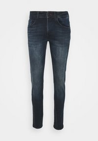 Jeans de mezclilla azul oscuro con corte ajustado, que cuentan con cinco bolsillos, cierre de botón y un desgaste sutil en los muslos, con una textura suave.