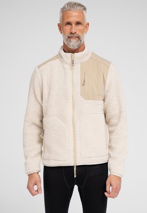Cremefarvet fleecejakke med en beige accentpanel, lynlåslomme og tekstureret overflade. Har et opretstående krave og lynlåslukning.