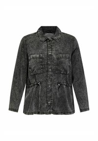 Črna kavbojka jakna s ovratnikom, dvema žepoma na prsih, elastičnim pasom in kontrastnimi šivi. Zgornja tekstura.