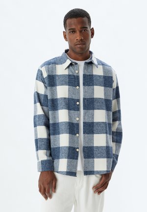 Button-up shirt in blue and white checkered pattern, made of wool, featuring a collar and long sleeves with button cuffs.