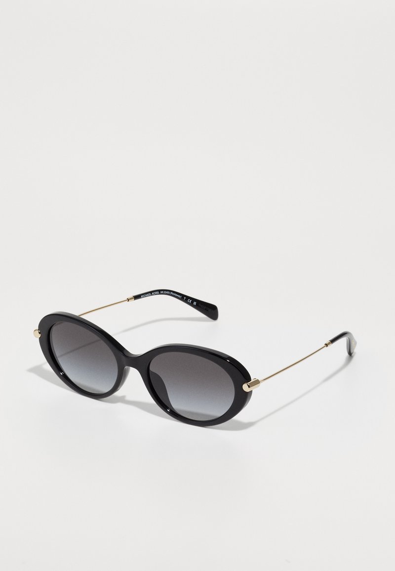 Óculos de sol ovais pretos com lentes degradê, hastes em metal com detalhes dourados e uma armação de plástico brilhante. Textura suave com bordas arredondadas.