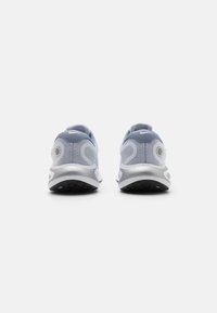 Gray and white sneakers with a mesh upper, rounded back, and silver accents on the heel, featuring a textured black outsole.