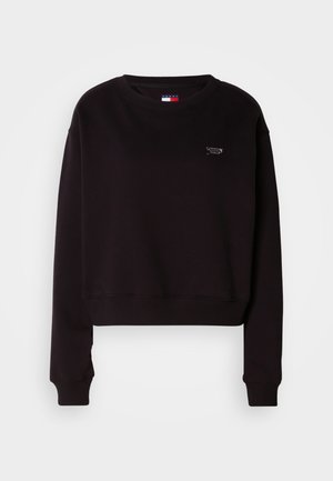 Sweatshirt preto encurtado com punhos e bainha canelados, gola redonda e um pequeno logótipo no peito. Feito de um tecido macio e texturizado.