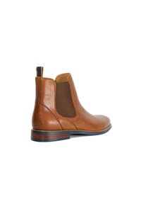 Brown leather Chelsea boot with elastic side panels, round toe, and stacked heel. Features a pull tab and contrasting brown sole.