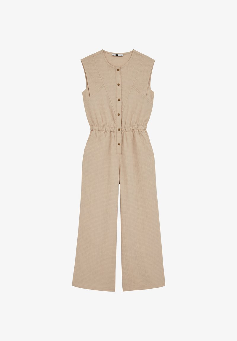 Combinaison beige sans manches en tissu texturé, avec boutons sur le devant, taille élastique et jambes larges. Présente des détails de couture subtils.