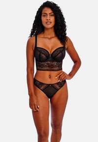 Black lace lingerie set featuring a bralette with underwire and matching high-waisted panties. Sheer floral patterns and scalloped edges.