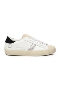 Witte sneakers met een textuursuede neuskap, zilveren zijkruis en zwarte hielaccent; voorzien van vetersluiting en rubberen zool.