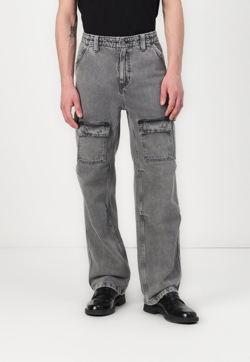 Cargo pants in faded gray denim, featuring a relaxed fit, multiple front pockets, and a straight leg design. Belt looped waist, smooth texture.