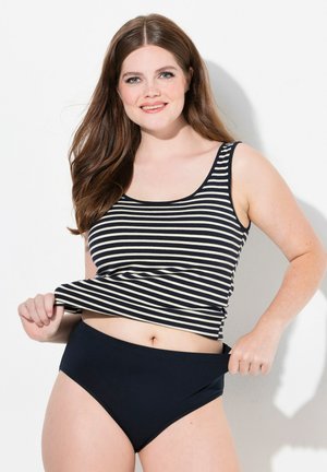 Gestreiftes Tanktop in Marineblau und Creme, kombiniert mit einfarbigen Marineblau hochgeschnittenen Unterteilen. Das Material wirkt weich und hat ein enganliegendes Design.