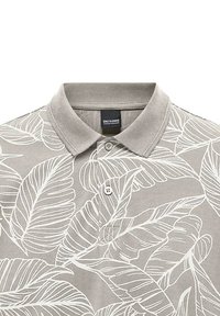 Gray polo shirt with white leaf pattern, featuring a classic collar and two-button placket, made from textured cotton blend fabric.
