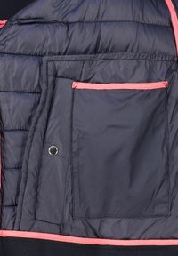 Navy puffer jacket interior with quilted texture, featuring a pink trim and pocket. Smooth fabric with a snap fastener detail.