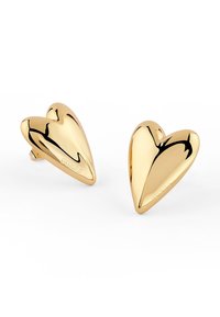 Kolczyki w kształcie serca z polerowanego metalu w odcieniu złota. Gładka powierzchnia o refleksyjnej jakości. Wytłoczony logo po jednej stronie.