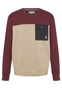 Felpa a maniche lunghe con corpo beige, dettagli color bordeaux, una tasca frontale nera con bottone e un piccolo logo sulla tasca.
