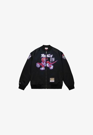 Chaqueta negra con cremallera con el logo del dinosaurio de los Toronto Raptors sosteniendo un baloncesto y el número 15, con un parche de NBA Hardwood Classics.