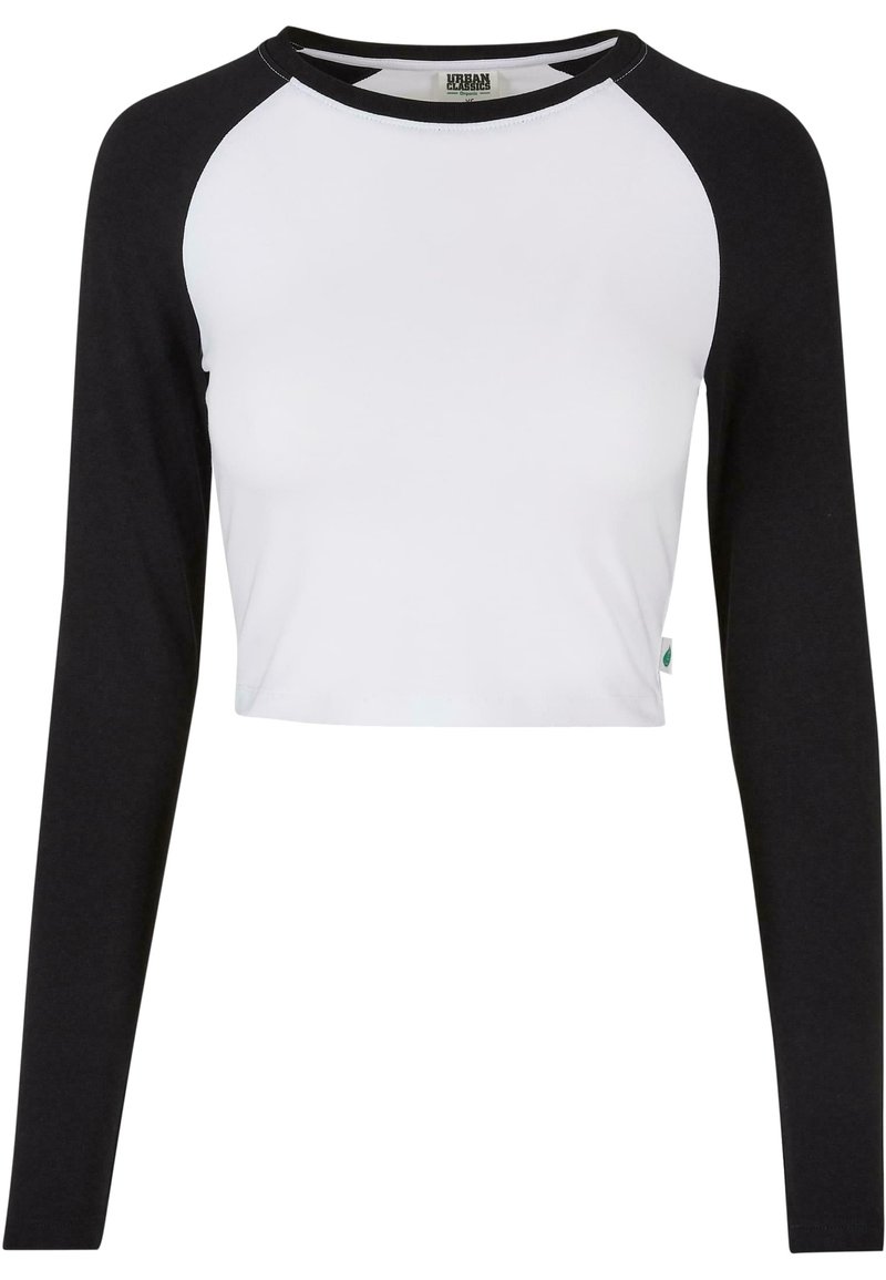 Crop top met een witte body en zwarte raglanmouwen, gemaakt van katoen met een ronde halslijn en een zijlabel detail.