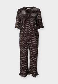 Ensemble de pyjama noir à pois blancs, avec un grand col à volants, des manches mi-longues, et des ourlets à volants sur le pantalon et les manches.