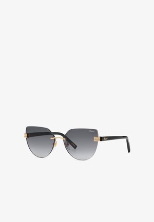 Lunettes de soleil œil-de-chat noires et dorées sans monture, avec verres dégradés foncés et détails dorés sur les branches et le pont.