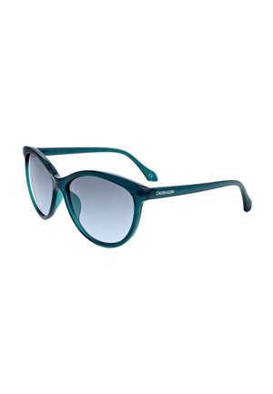 Occhiali da sole Calvin Klein verde scuro con montatura rotonda e lenti sfumate grigie, mostrati inclinati su sfondo bianco.