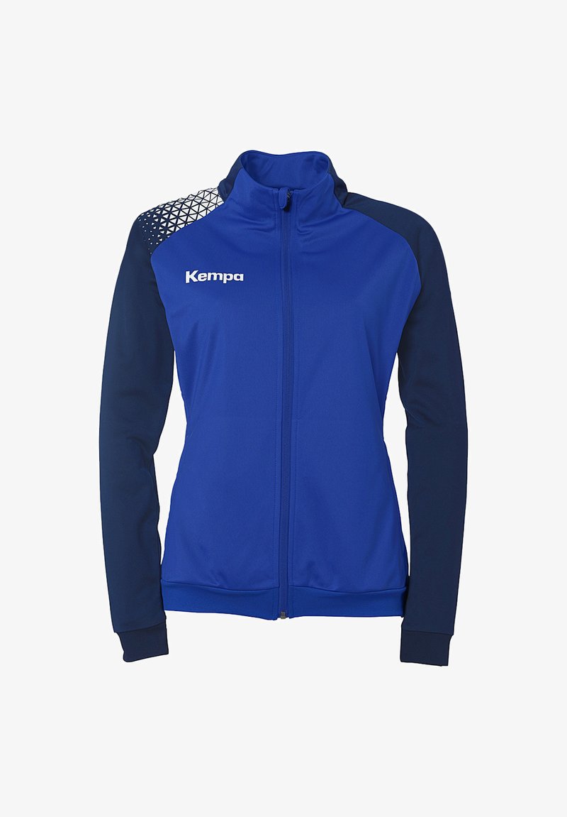 Blaue Sportjacke mit navyfarbenen Ärmeln, hohem Kragen und Reißverschluss. Mit geometrischem Muster auf der Schulter. Kempa-Logo auf der Vorderseite. Weicher Stoff.