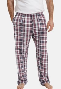 Plaid pajama pants in red, navy, and white. Features an elastic waistband with drawstring, side pockets, and a loose fit. Cotton material.