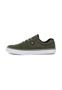Green suede and fabric sneaker with black accents, white rubber sole, and flat laces. Features logo on the side and reinforced heel.