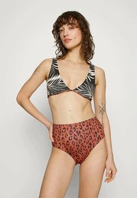 Høyt liv bikini med svart og hvit bladtrykk topp og rustfarget bunn med svarte leopardprikker, glatt stoff, minimal tilbehør.