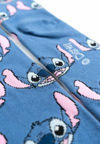 Calzini blu con un personaggio dei cartoni animati dai grandi occhi e orecchie rosa. Realizzati in tessuto morbido con un design lavorato a maglia e dettagli del logo.