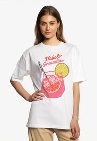 White cotton t-shirt featuring colorful print of a drink with ice, orange slices, and straw. Text reads "Diabolo Grenadine."