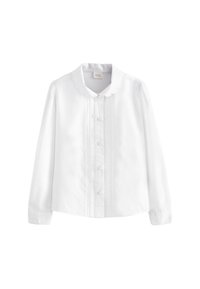 Blouse blanche à manches longues avec col festonné, boutonnage devant et plis pincés verticaux sur le devant.