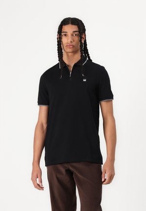 Black polo shirt with a half-zip collar and grey accents at the edges, made from a smooth fabric. Features a small logo on the chest.