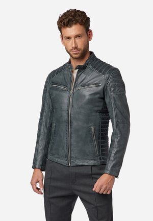 Gray leather jacket with quilted shoulder accents, multiple zippered pockets, high collar, and a fitted design. Textured finish throughout.