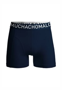 Mornariške boksarice s prilegajočo zasnovo, narejene iz mehkega materiala. Bele elastične pasnice z imenom blagovne znamke "MUCHACHOMALO."
