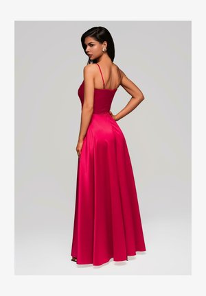 Abito da sera aderente in satin rosa vivace, con spalline sottili, gonna svasata e una texture liscia e lucida.