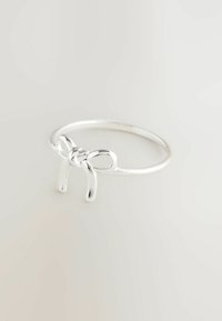 Silver ring featuring a bow design at the front. The band is smooth and slender, with a polished finish, highlighting the bow detail.