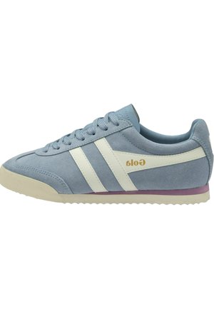 Sneaker in pelle scamosciata azzurro chiaro con strisce bianche, suola beige, dettaglio viola vicino alla suola e nome del marchio dorato sul lato.