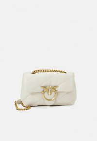 Fehér steppelt bőr kézitáska aranyszínű láncpánttal és kör alakú fém díszítéssel, melyen két madár motívum látható elöl.