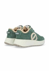 Green suede sneakers with beige accents, a textured white sole, and soft lining. Features a logo near the heel and round laces.