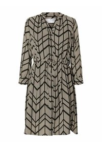 Klänning i svart och vitt mönster med ett chevronmönster, långa ärmar, V-hals och justerbar dragsko i midjan.