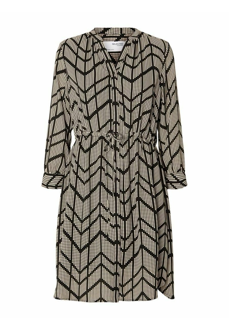 Klänning i svart och vitt mönster med ett chevronmönster, långa ärmar, V-hals och justerbar dragsko i midjan.