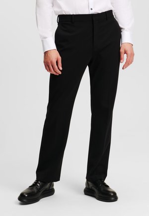 Schwarze Hose mit maßgeschneidertem Schnitt, aus glattem Stoff gefertigt. Verfügt über eine flache Vorderseite, Gürtelschlaufen und ein klassisches, gerades Bein-Design.