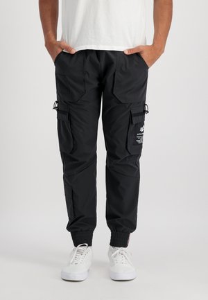 Black cargo pants made of lightweight material, featuring multiple pockets, elastic cuffs, and drawstring adjustment at the waist.