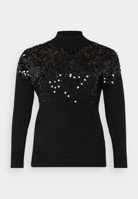 Juodas megztinis su aukštu kaklu ir ilgomis rankovėmis; papuoštas juodais ir sidabriniais blizgučiais viršutinėje dalyje, kad suteiktų papildomo tekstūriškumo.